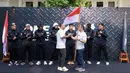 Ketua Umum Komite Olahraga Beladiri Indonesia (KOBI), Ardi Bakrie menyerahkan bendera merah putih sebagai simbol pelepasan saat konferensi pers mengenai pemberangkatan atlet MMA ke China yang berlangsung di Menteng, Jakarta Pusat, Senin (21/10/2024). (Bola.com/Bagaskara Lazuardi)