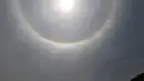 Pemandangan 'Halo Matahari' yang menghiasi langit Mexico City, Meksiko, Kamis (21/5). Menurut ahli meteorologi, fenomena optis berupa lingkaran cahaya atau pelangi di sekeliling matahari ini dibentuk oleh refleksi dari kristal es. (REUTERS/Edgard Garrido)