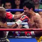 Petinju asal Filipina, Manny Pacquiao bertarung dengan lawannya asal Amerika Serikat. Floyd Mayweather saat pertandingan kelas welterweight di MGM Grand Garden Arena, Las Vegas, Nevada, Minggu (3/5/2015). (Joe Camporeale-USA TODAY)