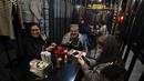 Wanita Iran mengenakan pakaian tahanan saat mereka makan di restoran berkonsep penjara "Sel 16" di Teheran, 4 Februari 2022. Sebagian dari hasil bisnis digunakan untuk membebaskan mereka yang mendekam di penjara Iran karena utang yang belum dibayar. (ATTA KENARE/AFP)