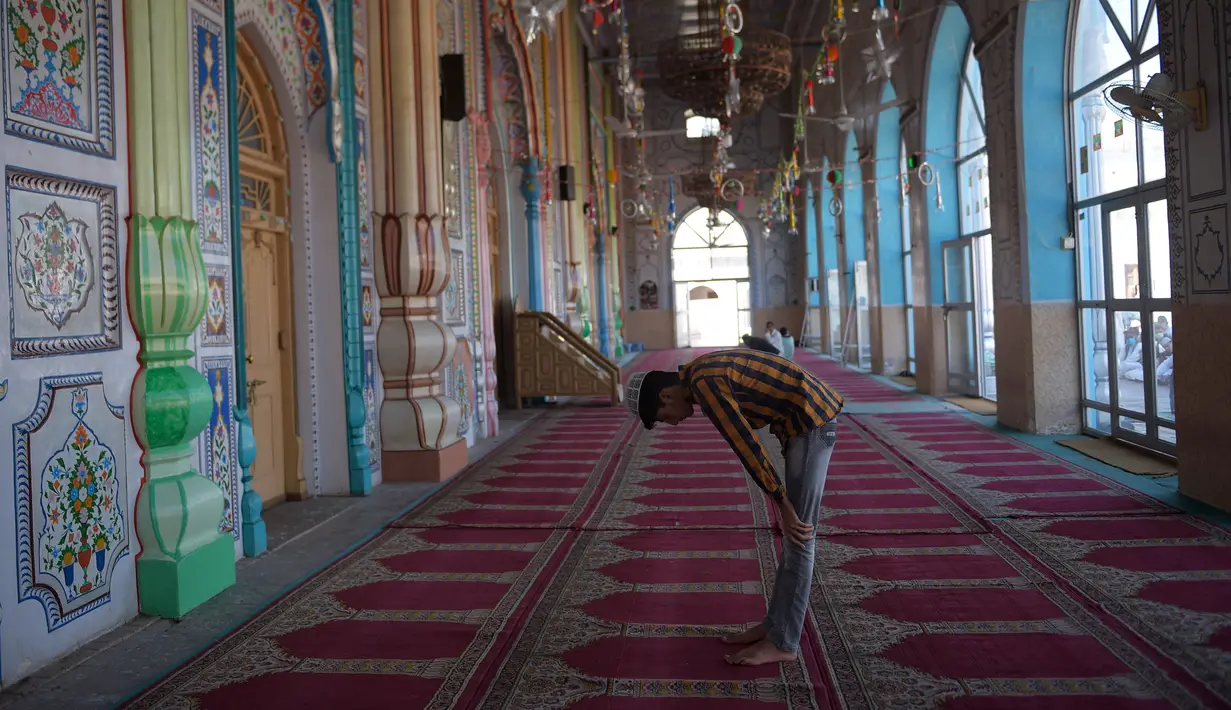 Seorang pria malaksanakan Salat di sebuah masjid selama penguncian nasional yang diberlakukan pemerintah sebagai tindakan pencegahan terhadap coronavirus COVID-19, di Rawalpindi, Pakistan (19/4/2020). (AFP/Farooq Naeem)