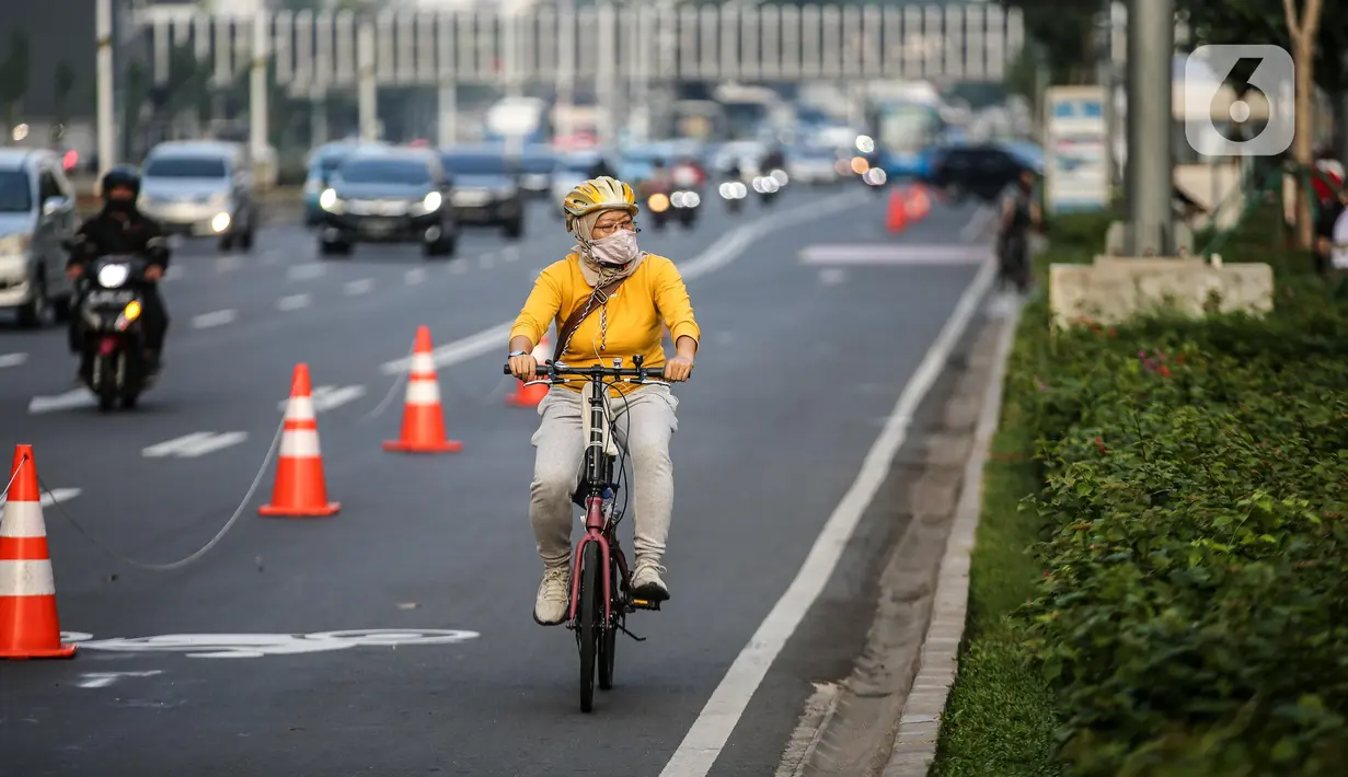 Warga menggunakan sepeda di jalur khusus sepeda di kawasan Jalan Sudirman, Jakarta, Selasa (14/7/2020). Keputusan tersebut ditetapkan, lantaran masih banyak pesepeda dan pejalan kaki di kawasan itu. (Liputan6.com/Faizal Fanani)