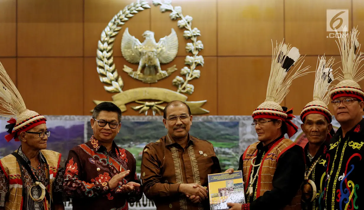 Wakil Ketua DPD Nono Sampono (ketiga kiri) dan Gubernur Kalimantan Utara Irianto Lambrie menerima buku dari dari masyarkat adat Krayan, di Ruang Delegasi, Gedung Nusatara IV, Kompleks Parlemen Senayan, Jakarta, Selasa (19/9). (Liputan6.com/Johan Tallo)