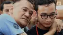 Aktor Tio Pakusadewo memeluk anaknya Nagra Kautsar sebelum sidang replik di PN Jakarta Selatan, Kamis (5/7). Pledoi atau nota pembelaan terdakwa Tio Pakusadewo ditolak seluruhnya oleh jaksa penuntut umum (JPU). (Liputan6.com/Immanuel Antonius)