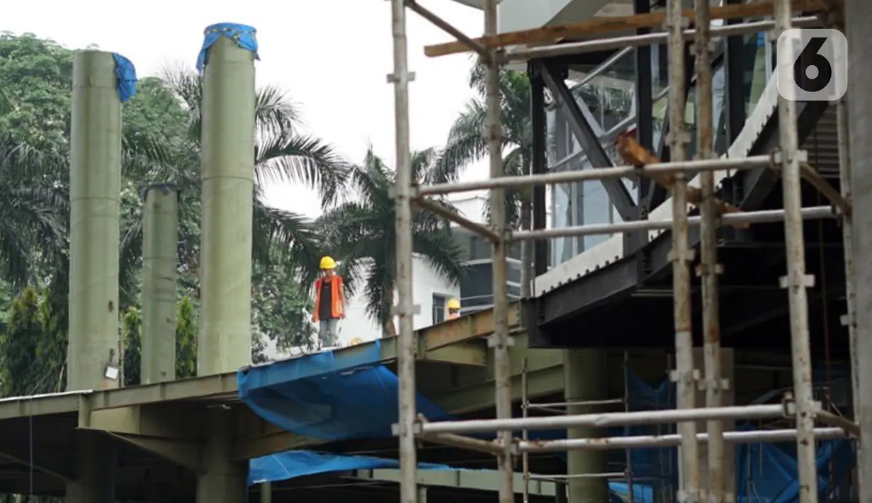 Pekerja menyelesaikan pembangunan proyek jembatan layang atau skybridge untuk integrasi antara Stasiun MRT ASEAN dengan Halte TransJakarta CSW di Jakarta, Sabtu (4/7/2020). Skybridge itu rencananya dibangun lima lantai dan ditargetkan rampung pada akhir 2020. (Liputan6.com/Immanuel Antonius)