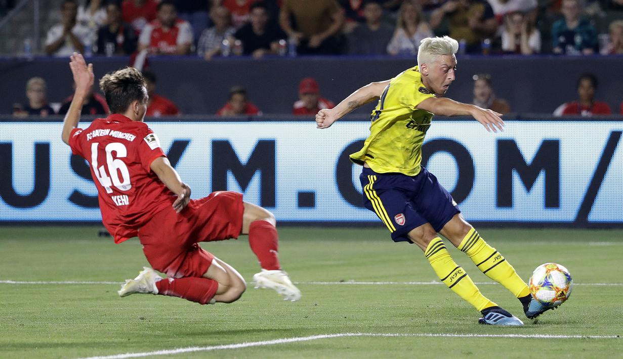 Pemain Arsenal, Mesut Ozil, melepaskan tendangan saat melawan Bayern Munchen pada laga International Champions Cup di Carson, Rabu (17/7/2019). (AP Photo/Marcio Jose Sanchez)