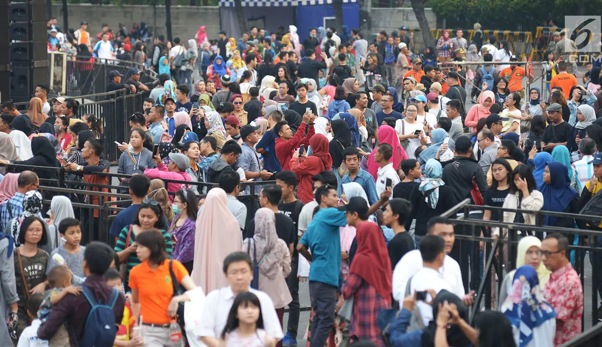 Warga berjalan kaki menuju panggung Jakarta Night Festival di Bundaran HI, Jakarta, Sabtu (22/6/2019). HUT ke-492 Jakarta tahun ini mengambil tema 'Wajah Baru Jakarta'. (merdeka.com/Imam Buhori)