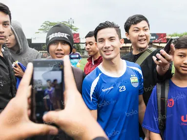 Gelandang Persib, Kim Jeffrey Kurniawan, dengan ramah melayani permintaan para Bobotoh yang memintanya foto bareng usai latihan di Lapangan Progresif, Bandung, Senin (2/5/2016). (Bola.com/Vitalis Yogi Trisna)