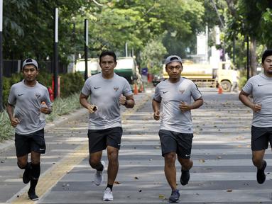 Pelatih Timnas Indonesia, Bima Sakti, bersama staf pelatihnya jogging menuju penginapan usai latihan di Stadion Madya Senayan, Jakarta, Rabu (21/11). Kebiasaan ini sering dilakukan sejak era Luis Milla. (Bola.com/M. Iqbal Ichsan)
