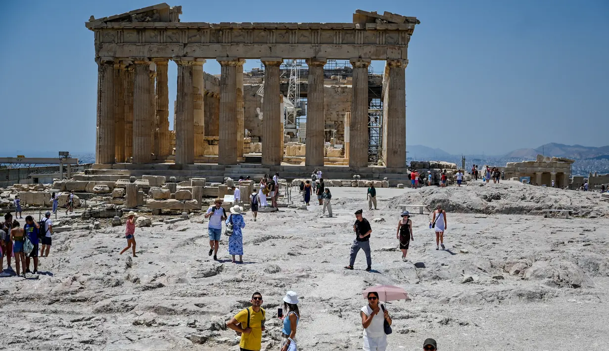 Wisatawan mengunjungi Acropolis di Athena, Yunani, Minggu (24/7/2022). Negara ini berada dalam cengkeraman gelombang panas yang dimulai pada 23 Juli dan akan berlangsung beberapa hari. Suhu diperkirakan akan mencapai 42 derajat Celcius (107 derajat Fahrenheit) di beberapa daerah.
(Louisa GOULIAMAKI / AFP)