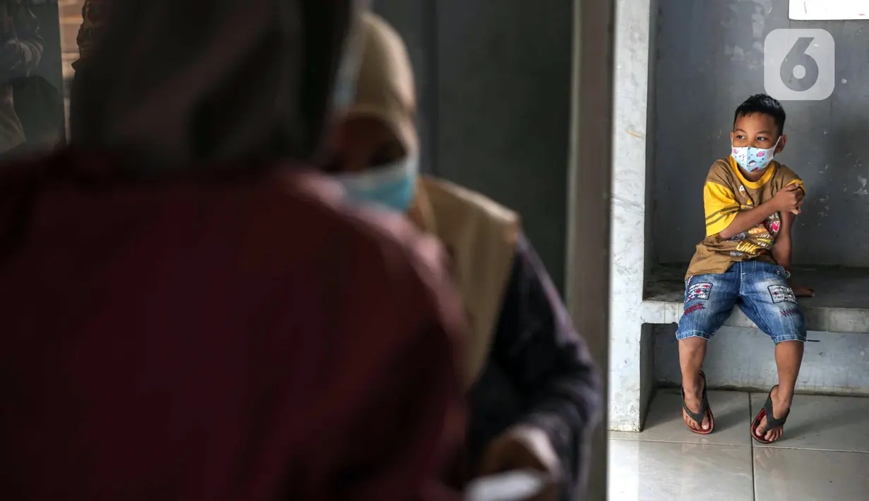 Seorang anak menunggu usai disuntik vaksin COVID-19 Sinovac di Pospol Polsek Pamulang, Tangerang Selatan, Banten, Kamis (6/1/2022). Vaksinasi dilakukan untuk melindungi anak-anak dari keterpaparan COVID-19, khususnya varian Omicron, yang berkembang cukup cepat. (Liputan6.com/Faizal Fanani)