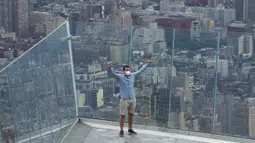 Seorang pria memandang cakralawa kota dari Edge, dek langit tertinggi di luar ruangan di Western Hemisphere saat dibuka kembali untuk umum di New York, Rabu (2/9/2020). Dek yang berada di lantai 100 menara utama Hudson Yards itu memiliki tinggi 1.100 kaki atau setara 335 meter (TIMOTHY A. CLARY/AFP)