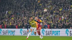 Pemain Fenerbahce, Youssef En-Nesyri (kiri) berebut bola dengan pemain Galatasaray, Abdulkerim Bardakci dalam laga lanjutan Liga Super Turki 2025/2026 antara Fenerbahce melawan Galatasaray di Chobani Stadium, Istanbul, Turki, Senin (01/12/2025) waktu setempat. (AP Photo/Khalil Hamra)