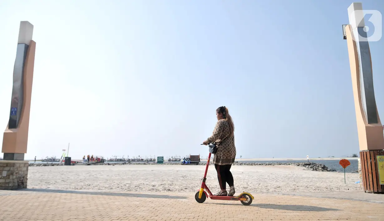 Pengunjung saat berkeliling menggunakan skuter listrik di Pantai Lagoon, Ancol, Jakarta, Rabu (9/10/2019). Pengelola Ancol kini menyediakan penyewaan skuter listrik berbasis aplikasi untuk pengunjung berkeliling kawasan pantai dengan tarif Rp.20.000 per 30 menit. (merdeka.com/Iqbal S. Nugroho)