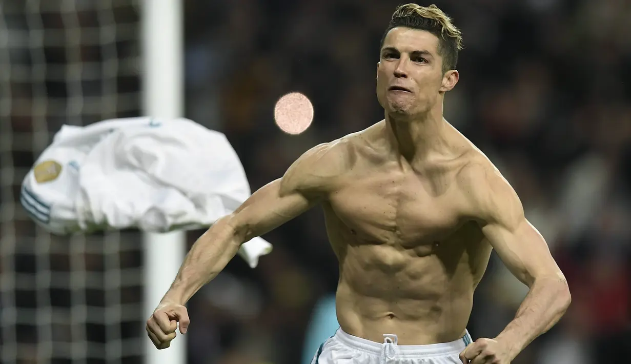 Striker Real Madrid, Cristiano Ronaldo, melakukan selebrasi pamer otot usai mencetak gol ke gawang Juventus pada laga Liga Champions di Stadion Santiago Bernabeu, Rabu (11/4/2018). Real Madrid takluk 1-3 dari Juventus. (AFP/Oscar Del Pozo)