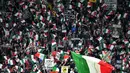 Suporter Juventus, mengibarkan bendera Italia saat mendukung timnya melawan Fiorentina pada  anjutan Serie A di Allianz Stadium, Turin, (20/9/2017). Juventus menang 1-0. (AFP/Alberto Pizzoli)