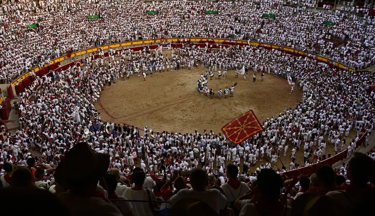 Orang-orang berkumpul di arena adu banteng pada hari terakhir Festival San Fermin di Pamplona, Spanyol, 14 Juli 2022. Ribuan orang dari seluruh dunia berduyun-duyun ke Pamplona selama sembilan hari setiap tahun untuk bersuka ria dalam pesta tanpa henti pada festival adu banteng yang ditangguhkan selama dua tahun terakhir karena pandemi virus corona COVID-19. (AP Photo/Alvaro Barrientos)