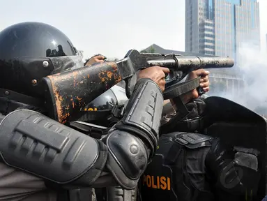 Seorang aparat bersiap-siap untuk menembakkan gas air mata, Jakarta, Kamis (21/8/2014) (Liputan6.com/Miftahul Hayat)