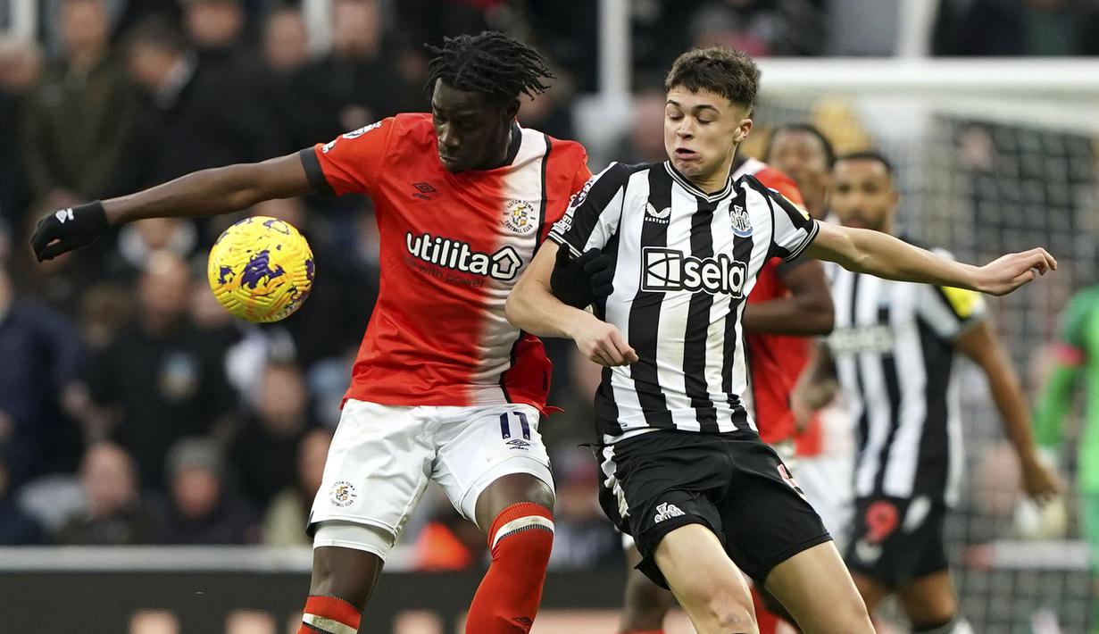 Pemain Luton Town, Elijah Adebayo (kiri) berebut bola dengan pemain Newcastle United, Lewis Miley pada laga lanjutan Liga Inggris 2023/2024 di St James' Park, Newcastle, Inggris, Sabtu (03/02/2024). (AP Photo/PA/Owen Humphreys)