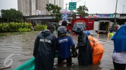 Petugas dari Suku Dinas Tata Air memasang mesin pompa untuk menyedot air banjir yang merendam Jalan Gunung Sahari, Jakarta, Selasa (21/2). Hujan yang mengguyur sejak Selasa dinihari membuat sebagian wilayah di Jakarta banjir. (Liputan6.com/Faizal Fanani)