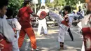 Pelatih atau Saboeum Taekwondo Indonesia Manroe Club saat melatih murid di kawasan Kanal Banjir Timur (KBT), Jakarta Timur, Senin (16/8/2021). Meski di ruang terbuka, latihan berlangsung dengan menerapkan protokol kesehatan. (merdeka.com/Iqbal S. Nugroho)