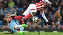 Pemain Manchester City, Aleksandar Kolarov (kiri) menghadang laju pemain Stoke City, Mame Biram Diouf pada lanjutan Premier League di Etihad Stadium, (8/3/2017). Manchester City bermain imbang 0-0.  (AFP/Anthony Devlin)
