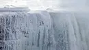 Es dan air mengalir di tepi Horseshoe Falls dari Air Terjun Niagara di Ontario, Kamis (31/1). Saat AS dilanda suhu yang lebih dingin dari Antartika, temperatur di Kanada juga menurun menjadi minus 18 derajat Celcius (Tara Walton/The Canadian Press via AP)