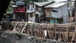 Sejumlah rumah hampir ambruk akibat amblesnya tanah di bantaran Anak Kali Ciliwung di Jalan Lodan Raya, Pademangan, Jakarta, Senin (19/11). Tiga buah rumah dilaporkan ambles. (Liputan6.com/Faizal Fanani)