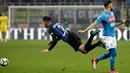 Pemain Inter Milan Joao Cancelo terjatuh setelah berebut bola dnegan pemain Napoli, Elseid Hysaj pada lanjutan Serie A di Giuseppe Meazza, Senin (12/3). Inter Milan  dan Napoli harus puas berbagi angka dengan skor akhir 0-0. (AP/Luca Bruno)