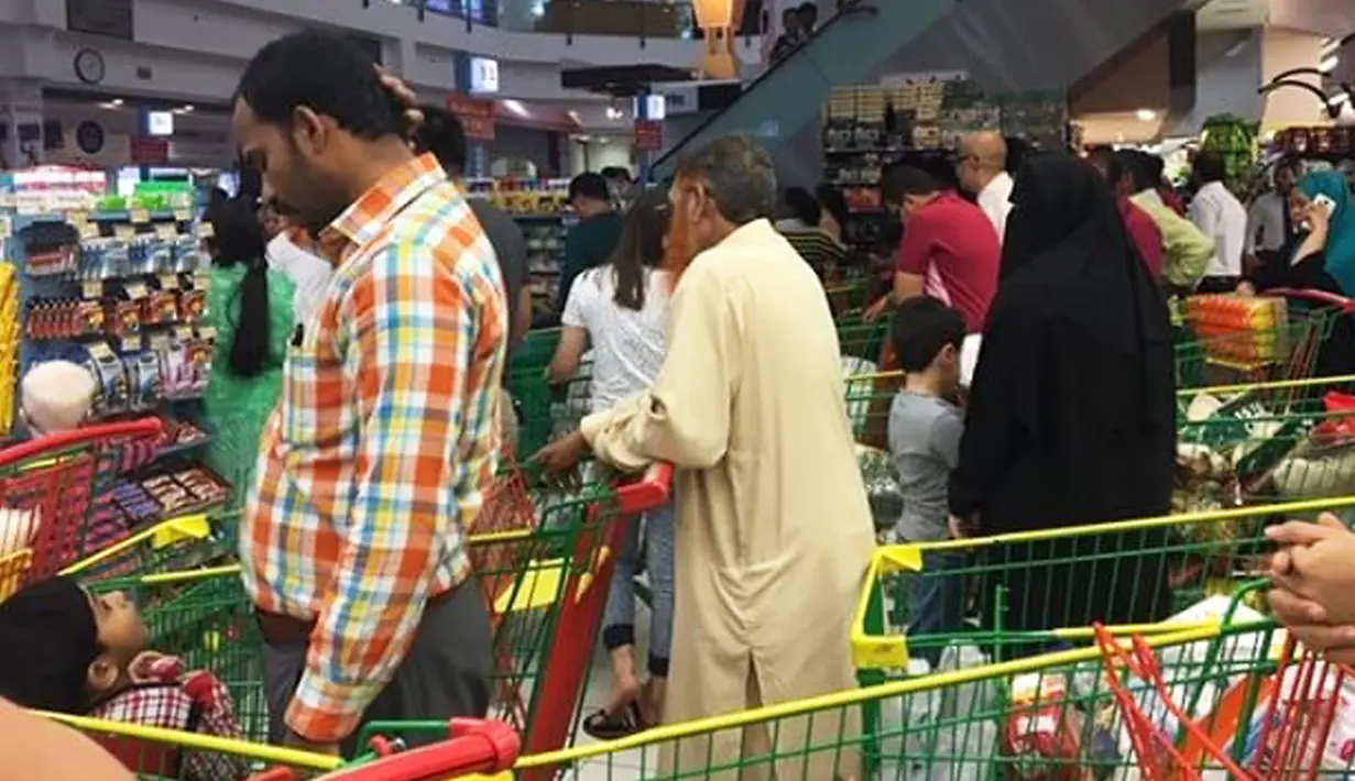 Warga Qatar berbelanja stok makanan di sebuah supermarket di Doha pascapemutusan hubungan diplomatik dengan lima negara Arab, Senin (5/6). Qatar sangat bergantung pada impor makanan yang sebagian besar dari negara-negara Teluk tersebut (@shalome05 via AP)