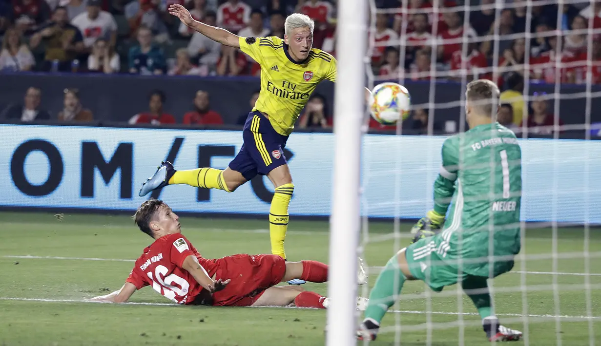 Pemain Arsenal, Mesut Ozil, melepaskan tendangan saat melawan Bayern Munchen pada laga International Champions Cup di Carson, Rabu (17/7/2019). (AP Photo/Marcio Jose Sanchez)