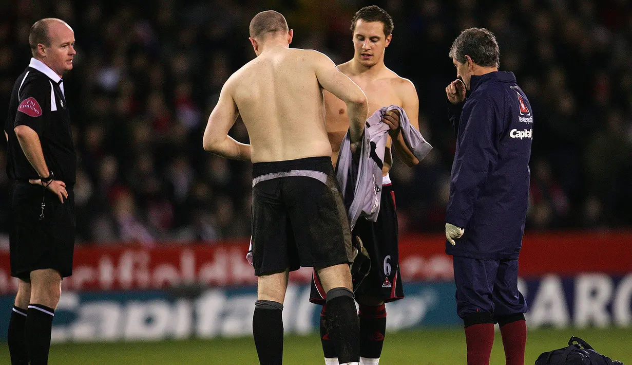 Pemain Sheffield United, Phil Jagielka (dua kanan), mampu menjadi kiper dadakan dengan cukup baik yang berbuah kemenangan saat bertemu Arsenal. Dirinya mampu menepis peluang emas dari Robin Van Persie. (AFP/Paul Ellis)