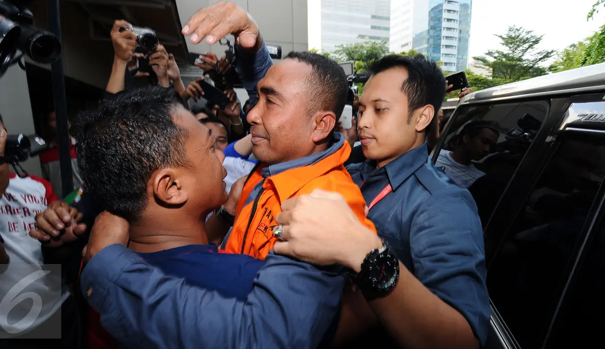 Bupati Buton nonaktif, Samsu Umar Abdul Samiun dipeluk kerabatnya jelang masuk ruang tahanan di Gedung KPK, Jakarta, Kamis (26/1). Samsu Umar tersangka dugaan suap Ketua Mahkamah Konstitusi Akil Mochtar, Oktober 2016. (Liputan6.com/Helmi Fithriansyah)