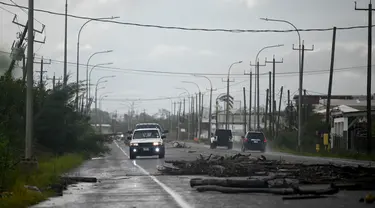Cabang-cabang pohon terlihat tumbang di jalan setelah Badai Lisa di Belize City, Belize, 3 November 2022. Badai Tropis Lisa menyebabkan banjir dan membuat sebagian negara itu menjadi gelap gulita. (Johan ORDONEZ/AFP)