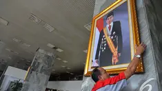 Petugas memasang foto Presiden Jokowi di pilar Gedung Nusantara III Kompleks Parlemen Senayan, Selasa (23/12/2014). (Liputan6.com/Andrian M Tunay)