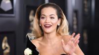 Penyanyi Rita Ora menyematkan mawar putih pada gaunnya saat berjalan di karpet merah Grammy Awards 2018, New York, Minggu (28/1). Mereka memilih warna putih untuk mendukung MeToo, gerakan melawan pelecehan seksual (Dimitrios Kambouris/GETTY IMAGES/AFP)