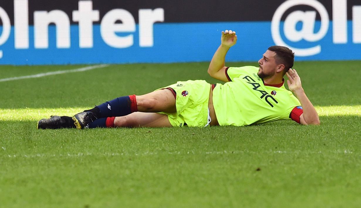 Aksi pemain Bologna, Mattia Destro yang tidur di lapangan usai laga Inter Milan vs Bologna pada lanjutan Serie A Italia di Stadion Giuseppe Meazza, Milan, (25/9/2016).  (AFP/Giuseppe Cacace)