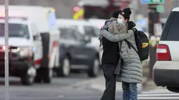 Wanita berpelukan di sudut Broadway dan Table Mesa Drive dekat toko King Soopers tempat penembakan terjadi di Boulder, Colorado (22/3/2021). Aksi penembakan tersebut terjadi di pusat perbelanjaan King Soopers di Kota Boulder, Colorado, Amerika Serikat. (AP Photo/Joe Mahoney)