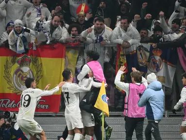 Pemain dan suporter Real Madrid merayakan gol yang dicetak Jude Bellingham pada pertandingan keenam Liga Champions 2024/2025 melawan Atalanta di Stadion Gewiss, Bergamo, pada Selasa 10 Desember 2024 waktu setempat atau Rabu 11 Desember 2024 dini hari Waktu Indonesia Barat. (Alberto PIZZOLI/AFP)