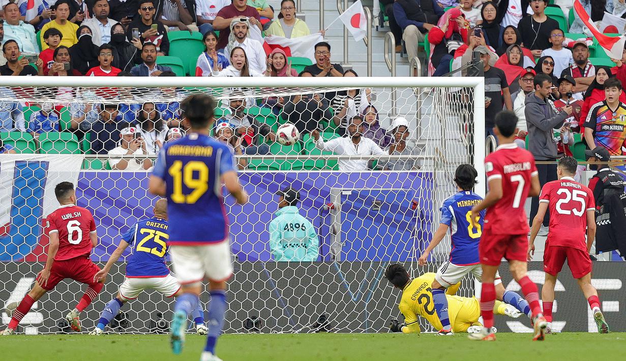 Kiper Timnas Indonesia, Ernando Ari Sutaryadi kebobolan gol ketiga dari Jepang melalui bunuh diri bek Justin Hubner (kanan) pada laga ketiga Grup D Piala Asia 2024 di Al-Thumama Stadium, Doha, Qatar, Rabu (24/1/2024) malam WIB. (AFP/Giuseppe Cacace)