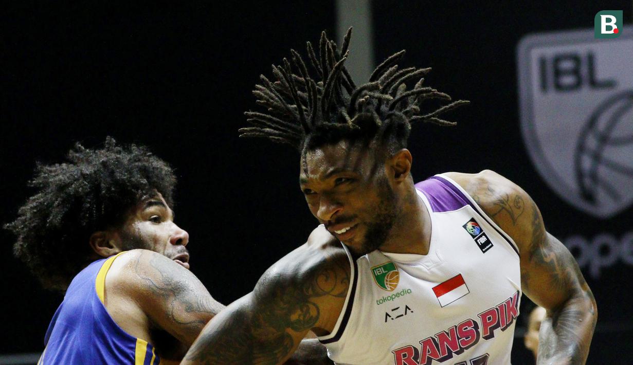 Pebasket Rans PIK Basketball, Hal Shane Heyward (kanan) dihadang pebasket Satria Muda Pertamina, Elijah Johad Foster, pada laga IBL 2022 di Hall Basket GBK, Jakarta, Rabu (19/01/2022). Satria Muda menang dengan skor 64-32. (Bola.com/M Iqbal Ichsan)