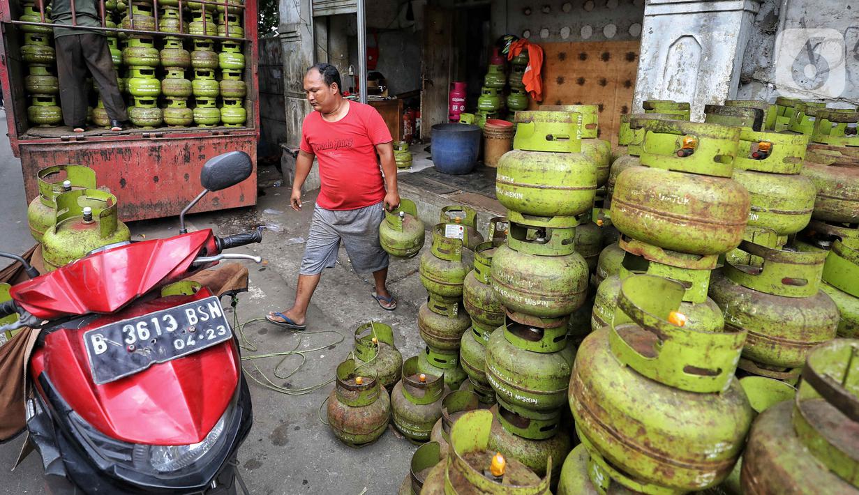 Pekerja menata tabung gas elpiji 3 kg ke atas sepeda motor untuk didistribusikan di kawasan Jakarta, Rabu (4/1/2023). Tahun 2023, pembelian elpiji 3 kg akan diperketat dengan menggunakan KTP. (Liputan6.com/Angga Yuniar)