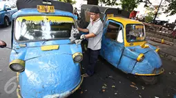 Seorang sopir membersihkan bemonya di kawasan Bendungan Hilir, Jakarta, Kamis (22/10/2015). Maraknya perkembangan transportasi online di Ibu Kota membuat keberadaan angkutan bemo kian terpinggirkan akibat kalah bersaing. (Liputan6.com/Immanuel Antonius)