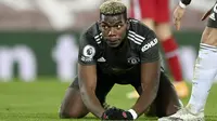 Ekspresi gelandang Manchester United, Paul Pogba setelah gagal mencetak gol ke gawang Liverpool pada pertandingan lanjutan Liga Inggris di Stadion Anfield, Senin (18/1/2021). (Michael Regan/Pool via AP)