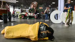 Seorang cosplay terlihat terbaring selama acara Comic Con Colombia 2018 di Medellin (16/11). Comic Con Colombia menyatukan penggemar dan pengusaha dari industri hiburan dan permainan berlangsung 16-18 November. (AFP Photo/Joaquin Sarmiento)