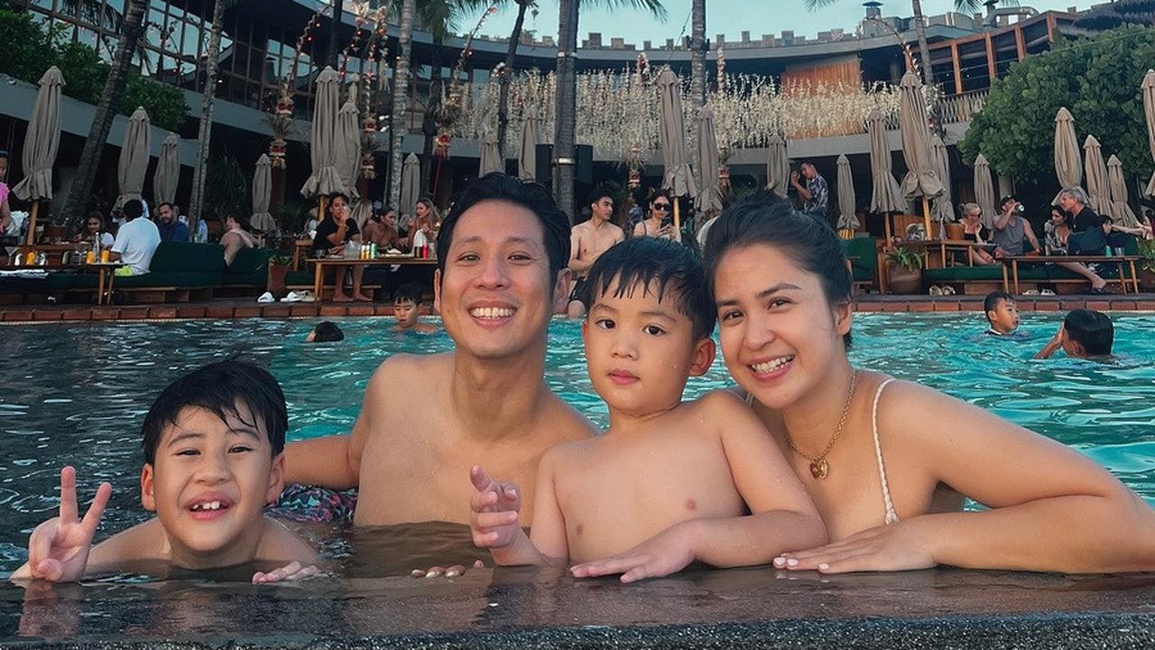 Saat sedang menikmati berenang bersama, keluarga bahagia ini sempat berpose bersama untuk memperlihatkan kedekatan mereka.