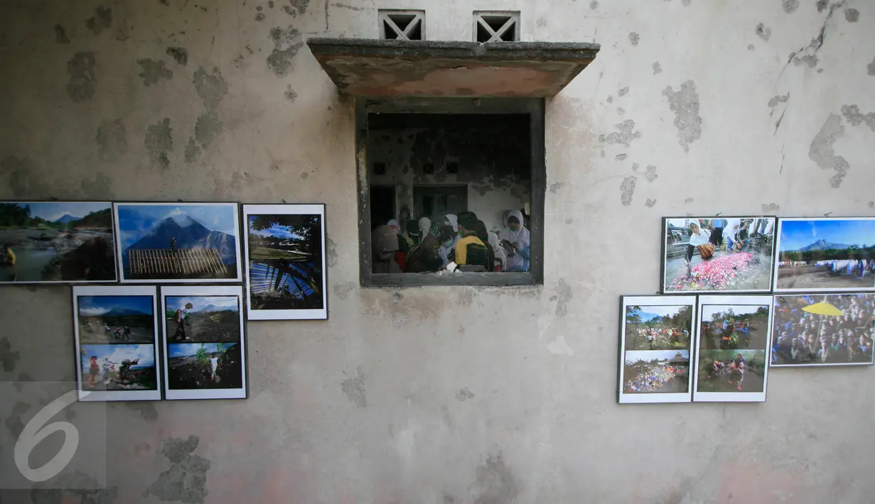 Para pengunjung menyaksikan pameran foto peringatan 5 tahun letusan Merapi 2010 di Dusun Petung,Sleman,  Yogyakarta, Kamis (29/10/2015). Tempat ini berjarak 7 Km dari puncak Merapi. (Boy Harjanto)