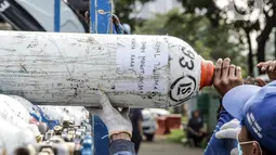 Petugas menurunkan tabung oksigen yang akan didistribusikan di Posko Rescue Oxygen, Monas, Jakarta, Senin (5/7/2021). Posko Rescue Oxygen didirikan untuk membantu penyediaan tabung oksigen bagi rumah sakit pemerintah dan swasta khusus COVID-19. (Liputan6.com/Faizal Fanani)