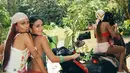 No Na Esther membonceng No Na Baila dengan bandana rajut manik-manik krem yang bingkai  rambut panjang merahnya. Ia mengenakan anting hoop emas, dan tank top putih berbordir bunga pink. Ia menyelesaikan gayanya dengan armlet emas berbentuk bintang laut yang menjadi detail paling mencuri perhatian. [@nonawav]