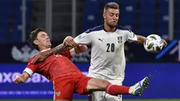 Bek Rusia, Yuri Zhirkov, berebut bola dengan gelandang Serbia, Sergej Milinkovic-Savic, pada laga Nations League di VTB Arena, Jumat (4/9/2020) dini hari WIB. Rusia menang 3-1 atas Serbia. (AFP/Alexander Nemenov)